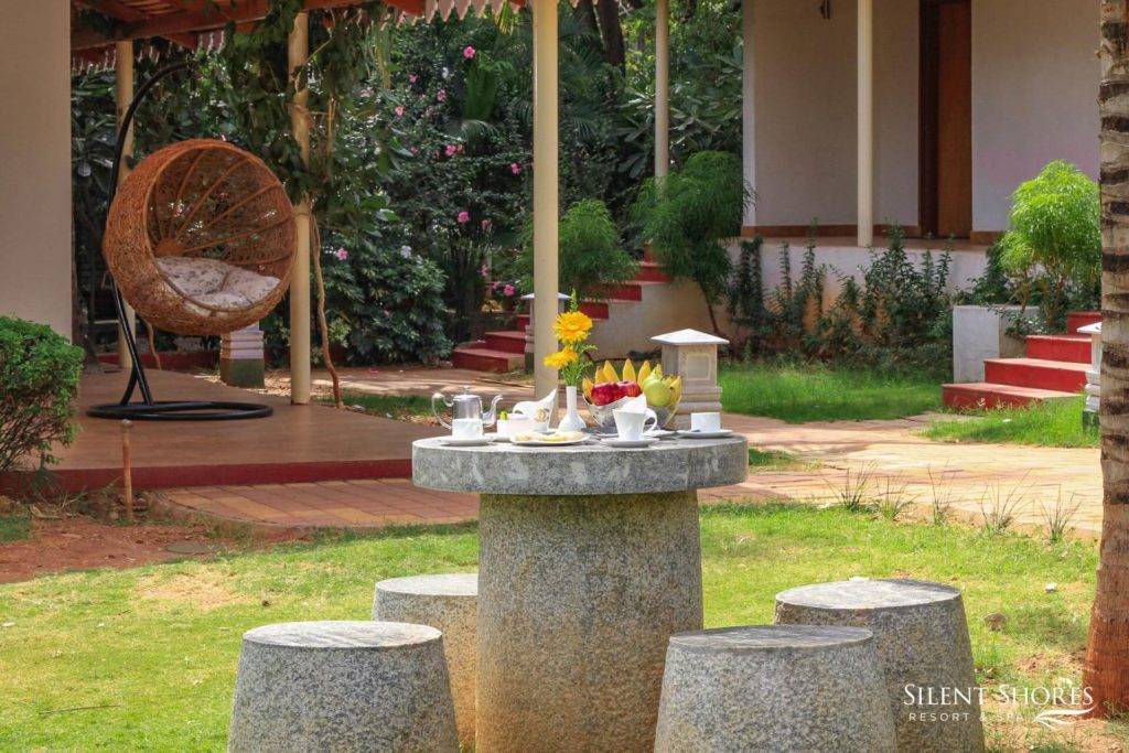 Round Stone table outside classic suite at Silent Shores -The best spa resort in Mysore - 5 star resort in Mysore