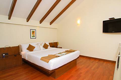 luxury king size bed with wall-TV - luxury & best hotel rooms in mysore, best resorts in mysore
